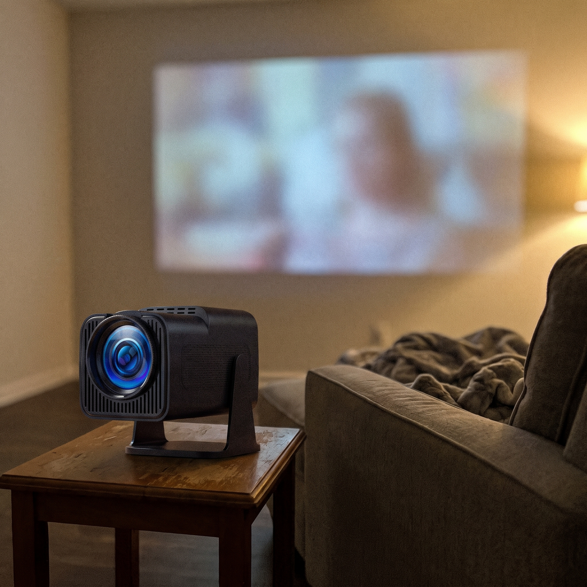 Mini projector on a side table beside the couch with a picture on the apartment wall