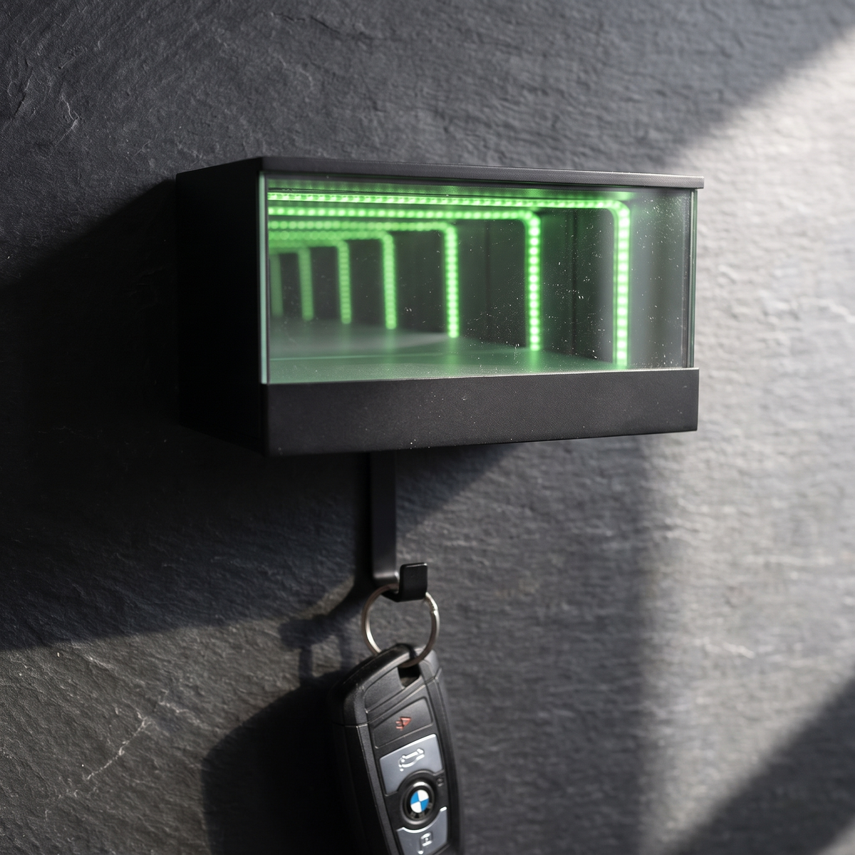 Close detail of the infinity LED key holder's lit tunnel effect with a key fob