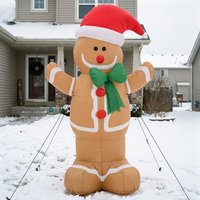 Inflatable gingerbread man on a snow covered front garden on an overcast day